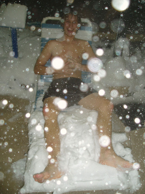 chris in a pool chair in the snow